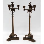 A pair of Italian Renaissance candlesticks - with four sconces and three elephant masks on a