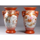 A pair of Meiji period Kutani vases - of baluster form with elephant mask handles and decorated with