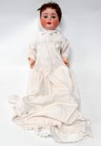 An early 20th century Heubach Koppelsdorf bisque headed doll - with blue sleeping eyes,