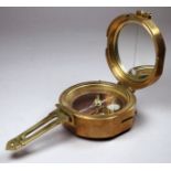 A brass military style marching compass - featuring sine table to cover, width 8cm.
