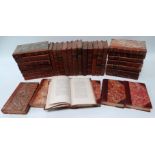 A quantity of leather bound books - mostly religious treatises and a quantity of Punch Library of