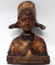 An Art Nouveau plaster bust of a Dutch girl - polychrome painted, signed Paul Nelson, height 41cm.