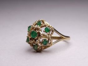 A 9ct yellow gold emerald cluster ring - with rope twist floral setting, ring size N, weight 4.2g.