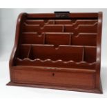 An early 20th century mahogany stationery casket - the tambour fall opening to reveal an arrangement