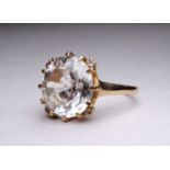 A 9ct yellow gold gem set ring - the large white stone possibly topaz, within a claw setting, ring