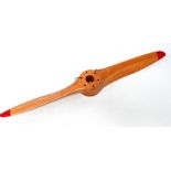 A laminated birch drone propeller - with six hub bolt holes, finished in clear varnish with red