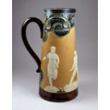 A Royal Doulton salt glazed stoneware jug - decorated in relief with footballers and athletes,