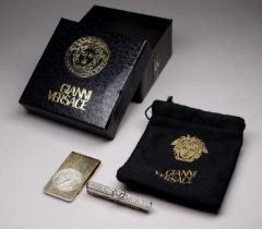 A Versace tie clip - set with rhinestones in two rows either side of Medusa mask, with retail bag