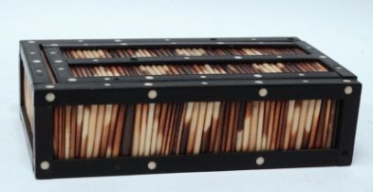 A porcupine quill and ebony box - with sliding cover and bone disk inserts, width 7cm.