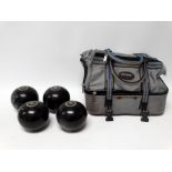 Set of four Henselite Super-grip garden bowls - size 5, in a carrying case.