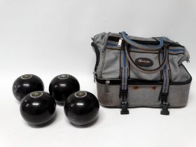 Set of four Henselite Super-grip garden bowls - size 5, in a carrying case.