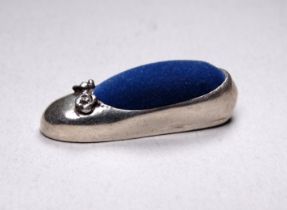 A silver pin cushion - modelled as a shoe, length 4cm, total weight 12.2g.