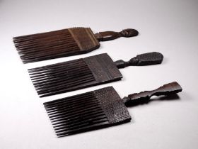 Three African fruit wood combs - largest width 20.5cm.