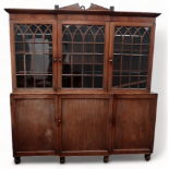 A George III mahogany breakfront cabinet bookcase - with a broken cornice above astragal glazed