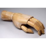 A late 20th century lay figure hand - natural beech, height 19cm.
