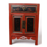 A late 19th century Chinese red lacquer cabinet - with cleated top above a frieze drawer and a