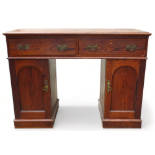 A Victorian pitch pine kneehole desk - the rectangular moulded top above an arrangement of two