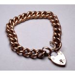 A 9ct gold curblink bracelet - with heart shaped clasp, weight 18g.