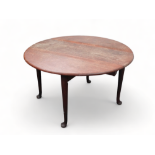 A George III mahogany drop leaf table - the oval top above a gate leg action and turned tapering