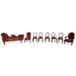 A Victorian rosewood salon suite - comprising eight pieces, upholstered in a red floral brocade,