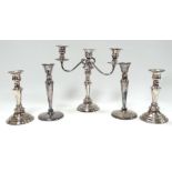 A 20th century silver plated three branch candlestick - of circular baluster form with wrythen arms,
