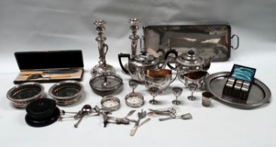A quantity of silver plated wares - to include a pair of candlesticks, a tea service, a