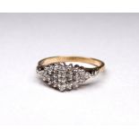 A 9ct gold diamond set dress ring - of stepped navette form, with twenty six stones, weight 2.7g.