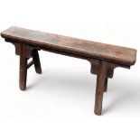 A late 19th century Chinese elm bench - bearing wax export seal, with moulded plank seat above a