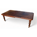 A Victorian mahogany extending dining table - the rectangular moulded top above a winding mechanism,