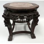 A late 19th century Chinese hardwood jardiniere stand - the shaped circular top inset with rouge