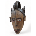 An African polychrome painted mask - height 67cm.