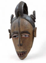 An African polychrome painted mask - height 67cm.