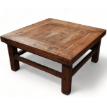 A late 19th century Chinese hardwood low table - cleated plank top and raised on square legs