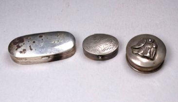 An oval silver hinged box - width 4.8cm, together with two white metal hinged boxes.