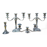 A pair of silver plated three branch candlesticks - with wrythen arms, turned baluster supports