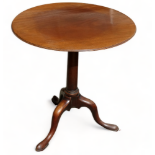 A Georgian tilt top table - the circular top on a columnar support and tripod base with cabriole