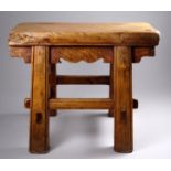 A late 19th century Chinese hardwood low stool - the rectangular top above a shaped apron and with