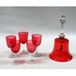 A large cranberry glass bell with clear glass handle and clapper in the form of a bird - height