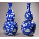 A pair of late 19th/early 20th century Chinese double gourd vases - with prunus blossom