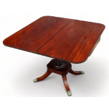 A Regency mahogany tea table - the rectangular top above a turned support and plinth base with short