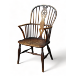 A 19th century ash and elm Windsor chair - with a hoop back and wheel pierced splat above a solid