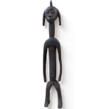 A late 19th century African hardwood figure - standing with arms by his side, height 115cm.