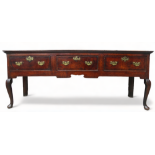 A George III oak and mahogany banded dresser base - the rectangular planked top above three