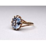 A 9ct gold set topaz ring - the oval cut stone within a claw mount, ring size M, weight 2.2g.