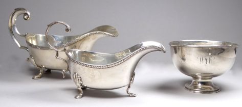 A silver sauce boat - London 1939, with reeded rim and raised on pad feet, together with another