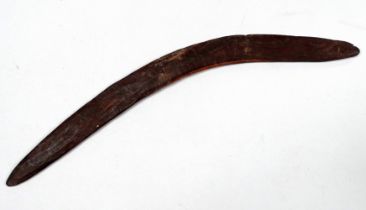 A late 19th/early 20th century native Australian boomerang - with incised decoration, length 66cm.