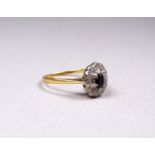 An 18ct gold diamond and sapphire dress ring - the oval central stone within a band of diamonds,