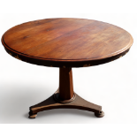 A Victorian mahogany loo table - with a circular top raised on a tapering octagonal support and