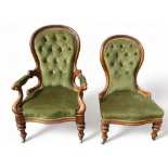 A Victorian walnut button upholstered spoon back chair - with open arms and turned tapering legs,