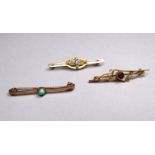 A 9ct gold bar brooch - set with a red stone, a 9ct gold pearl set bar brooch and another 9ct gold